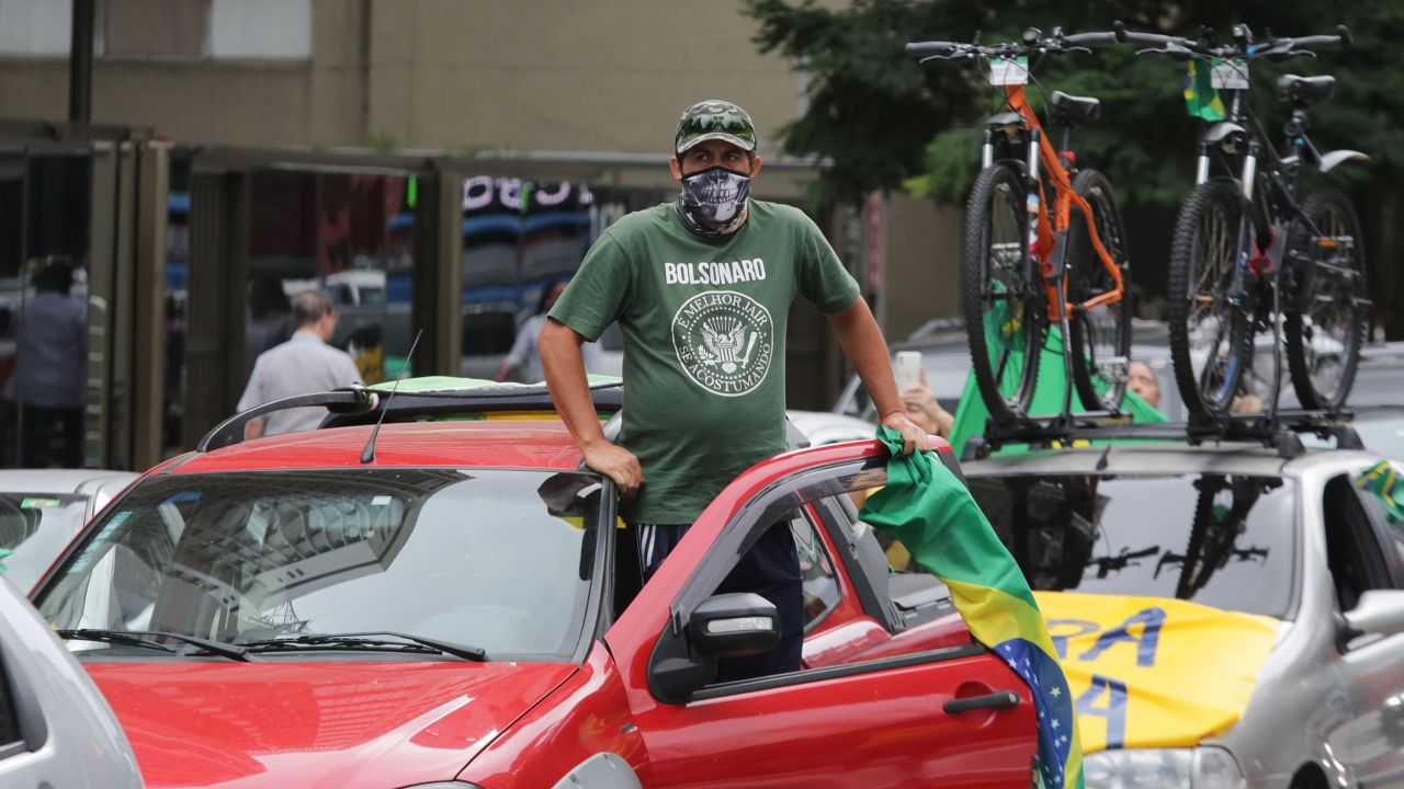A group of protesters, supporters of Brazilian President Jair Bolsonaro, rally in favor of the reopening of commerce in Sao Paulo, Brazil, on April 11.