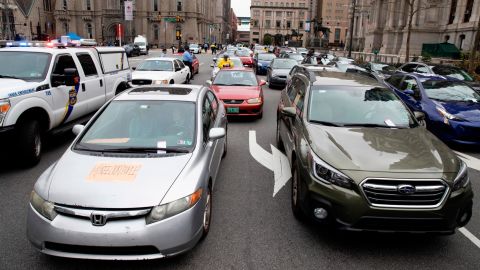 Police ticket protesters' cars blocking traffic as demonstrators in Philadelphia call for officials to release people from jails, prisons and immigration detention centers on March 30.