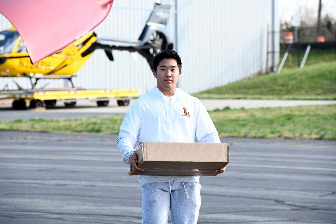 Kim carries essential supplies to his plane. He hopes to attend the US Naval Academy after high school. 