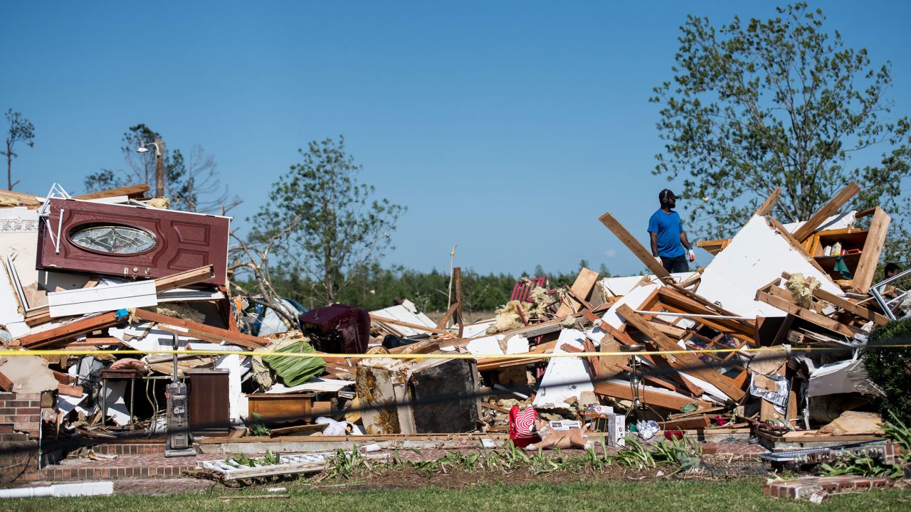 A man looks through the rubble of a destroyed home in Nixville, South Carolina.
