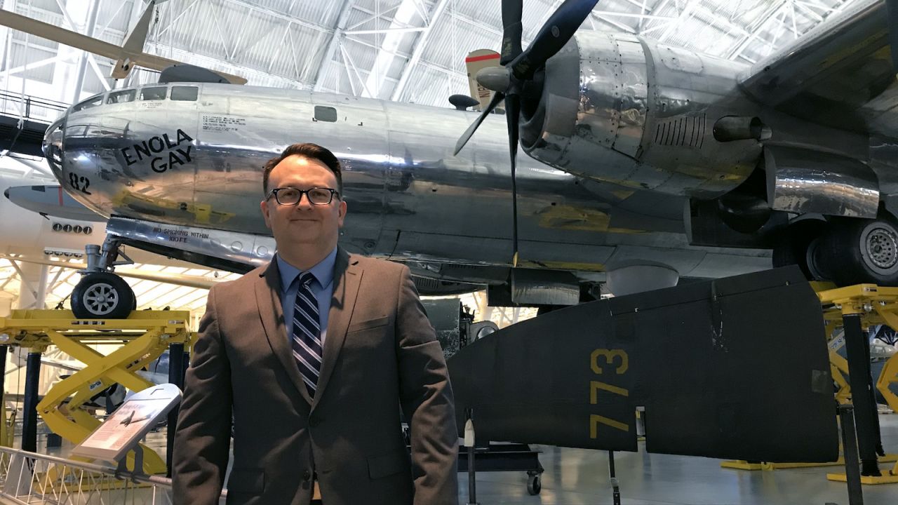 <strong>A somber artifact:</strong> Jeremy Kinney, curator at the Smithsonian Air and Space Museum, stands in front of Enola Gay. "This is a very somber artifact," Kinney says of the bomber.