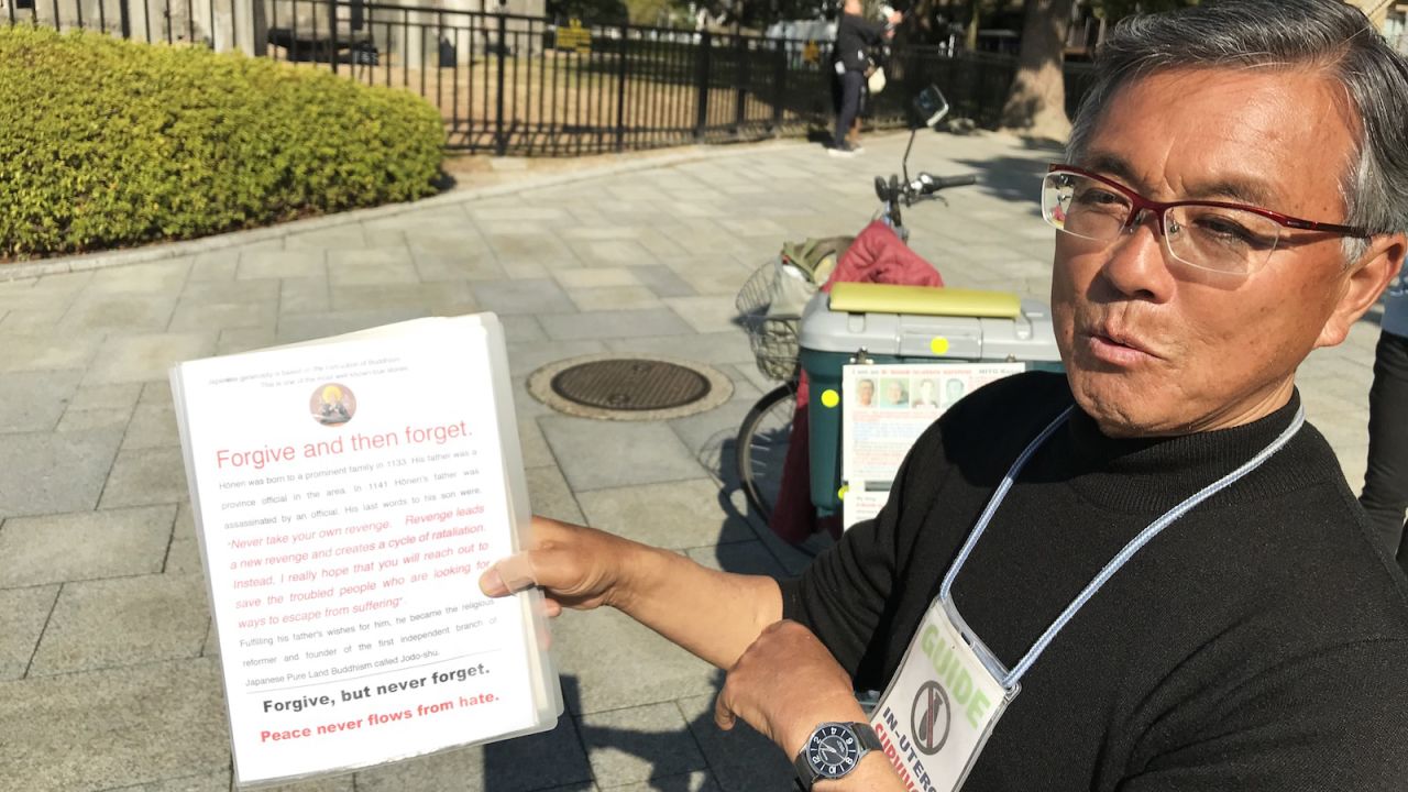 <strong>Forgive but never forget: </strong>Kosei Mito has prepared notebooks for visitors to read details of the atomic bombing of Hiroshima. In this photo, he shows a page explaining his philosophy about the bombing. 