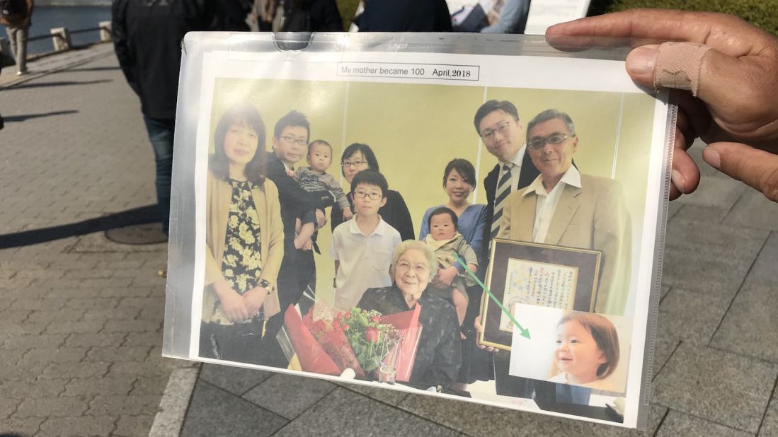 <strong>Bomb survivors: </strong>Kosei Mito shows a photo of his extended family, including his 102-year-old mother, who was pregnant with him when the atomic bomb was detonated over Hiroshima.