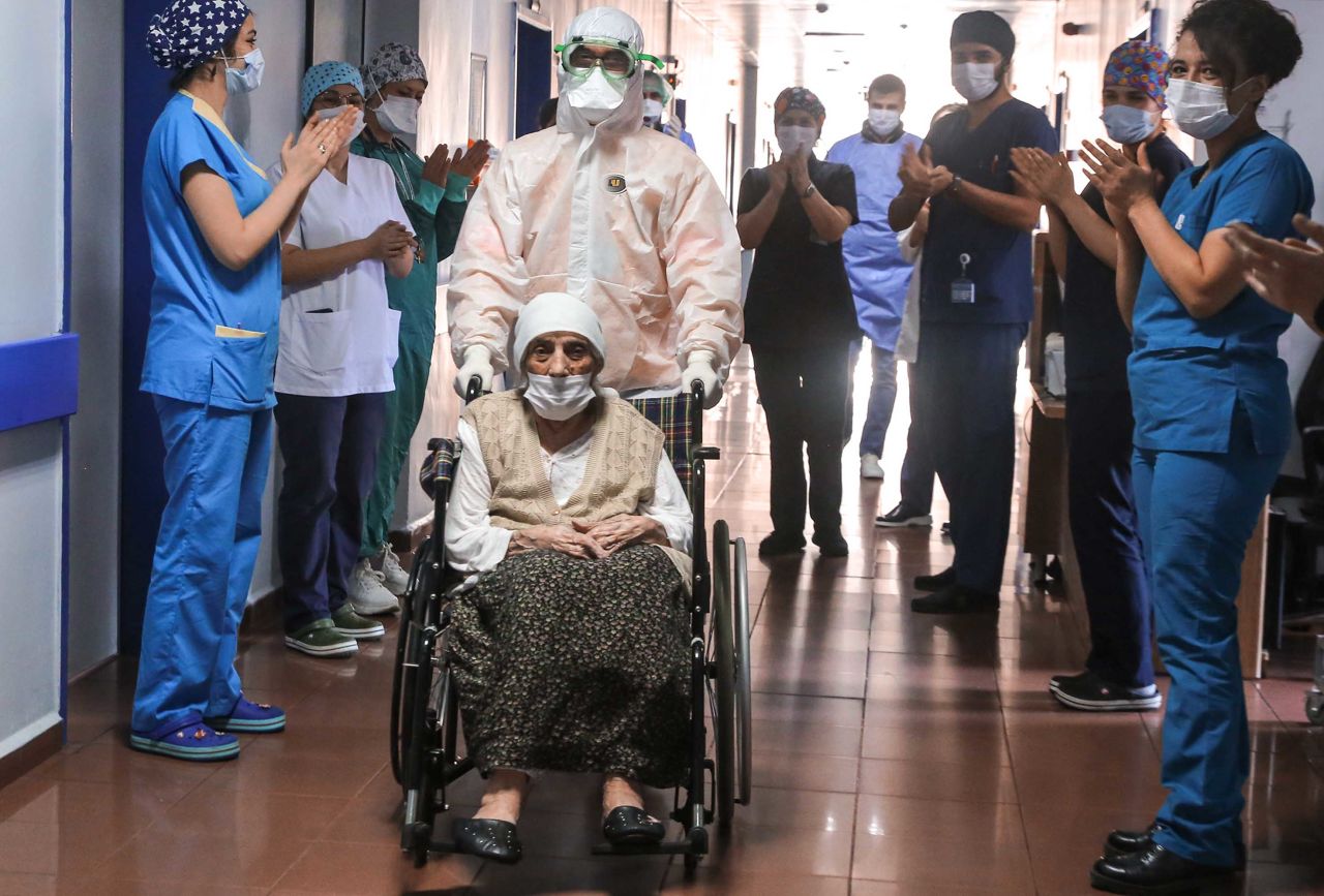 Medical workers in Istanbul clap for 107-year-old Havahan Karadeniz as she is discharged from the hospital on April 13, 2020. She had just recovered from the coronavirus.