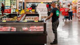 A store associate cleans the meat case at the Local Market Foods store in Chicago, Illinois, on April 8, 2020, during the coronavirus outbreak. (Photo by Kamil Krzaczynski/AFP/Getty Images)