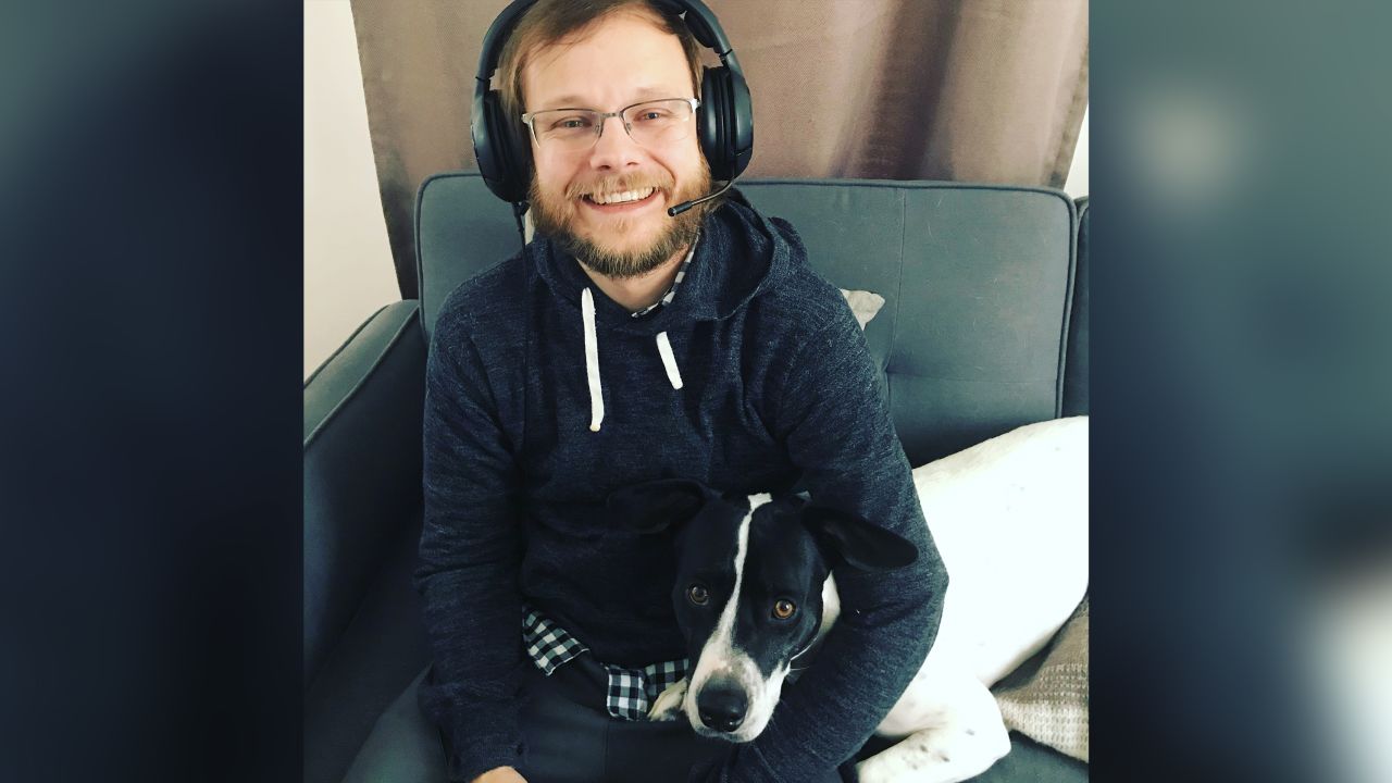 Trevor Andrews, a violist and "Apex Legends" video game coach, poses with his dog, Charlie, in April 2019.