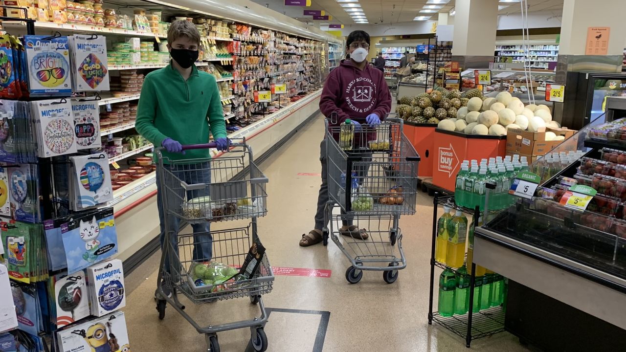 Matt Casertano and Dhruv Pai shop for groceries for senior citizens who are at risk going out during the pandemic.