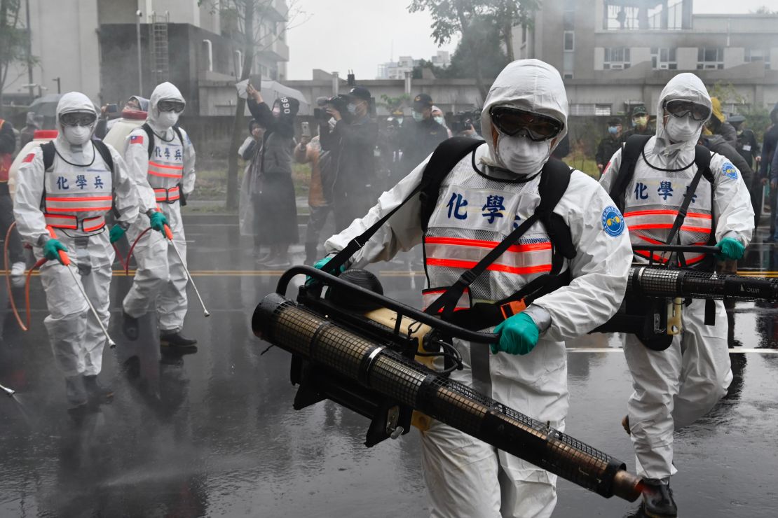 Soldiers from the military's chemical units take part in a drill to help slow the coronavirus' spread in the Xindian district near Taipei on March 14 