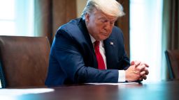 WASHINGTON, DC - APRIL 14: President Donald Trump looks at his remarks during a meeting with recovered coronavirus (COVID-19) patients in the Cabinet Room at the White House April 14, 2020 in Washington, D.C. During the April 13 Coronavirus Task Force briefing, Trump said the president had "total authority" to reopen the U.S. economy. (Photo by Doug Mills-Pool/Getty Images)