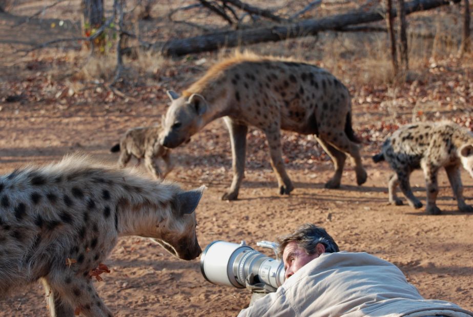 Wildlife photographer Kim Wolhuter and his family live on a 60,000-hectare reserve in Zimbabwe with wild hyenas as their neighbors. 