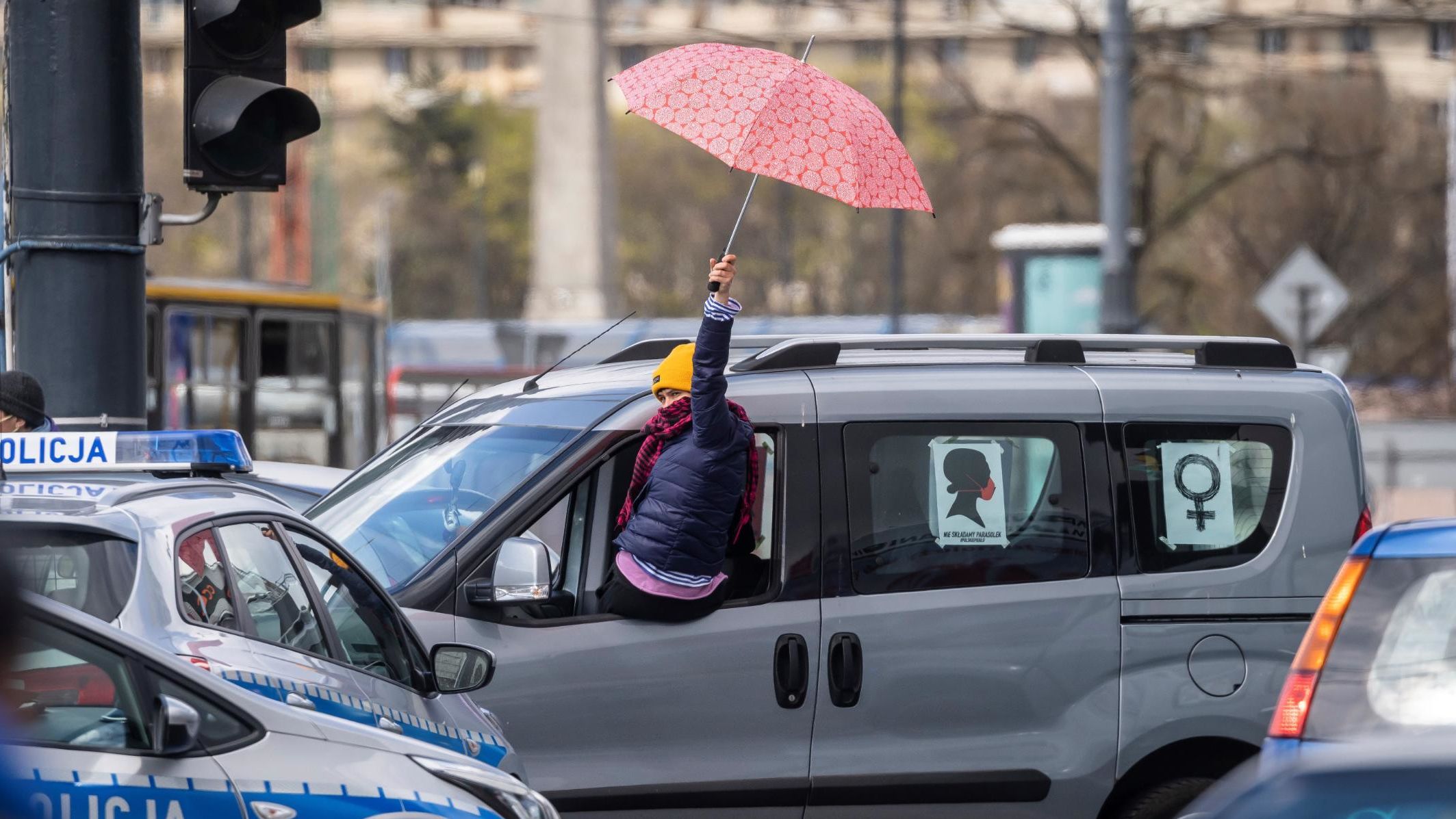Women protest from their cars with umbrellas, a symbol of the abortion rights movement.