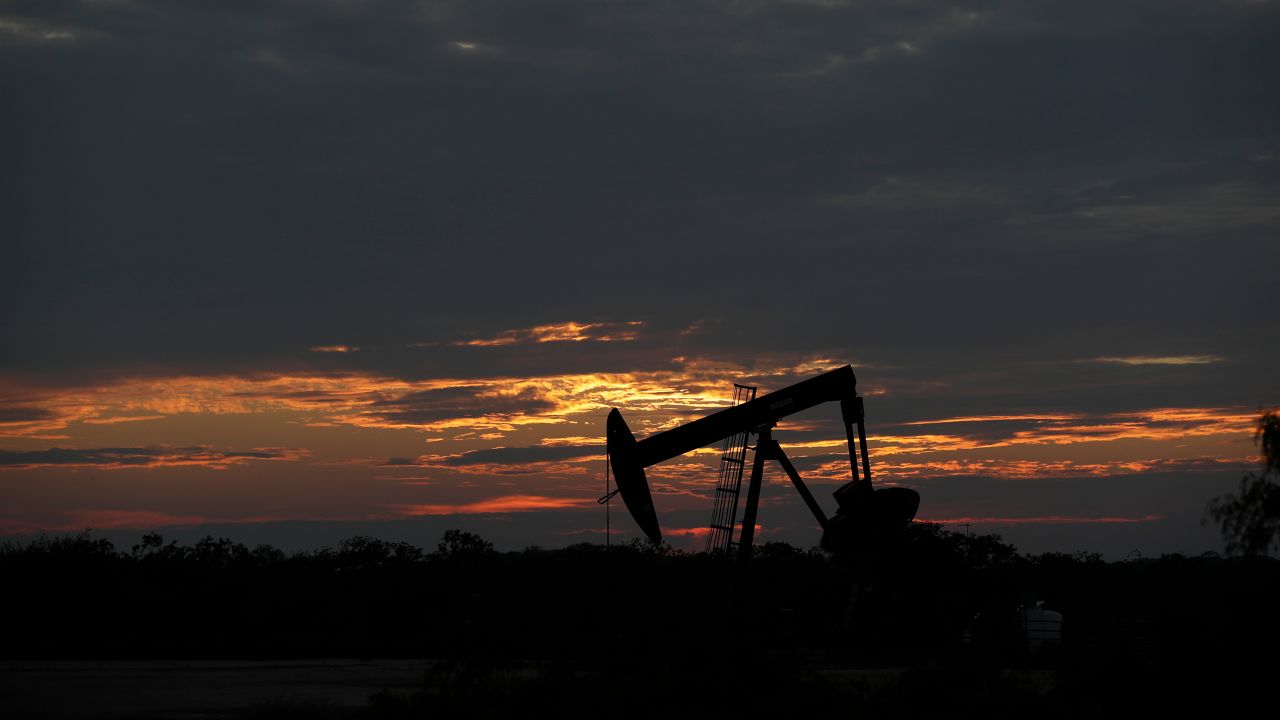The sun sets behind an idle pump jack near Karnes City, Texas, Wednesday, April 8, 2020. Demand for oil continues to fall due to the new coronavirus outbreak. (AP Photo/Eric Gay)