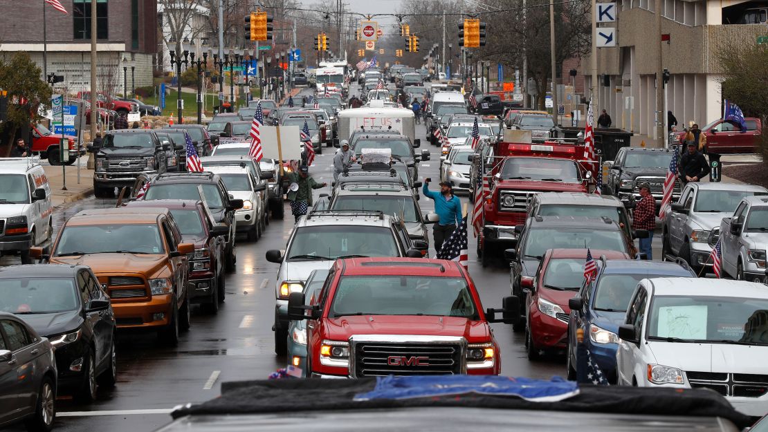 Vehicles sit in gridlock during a protest in Lansing, Mich., Wednesday, April 15, 2020. Flag-waving, honking protesters drove past the Michigan Capitol on Wednesday to show their displeasure with Gov. Gretchen Whitmer's orders to keep people at home and businesses locked during the new coronavirus COVID-19 outbreak. 