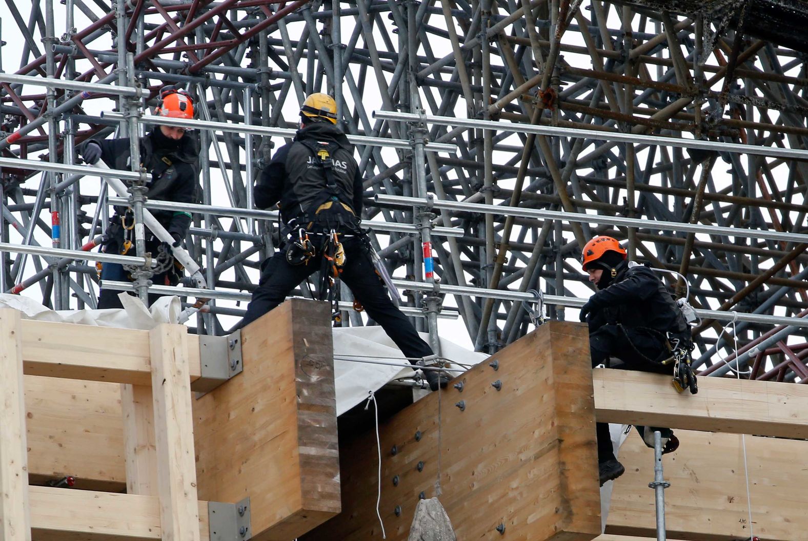 Professional mountain climbers work on a part of the Notre Dame Cathedral restoration on January 29.