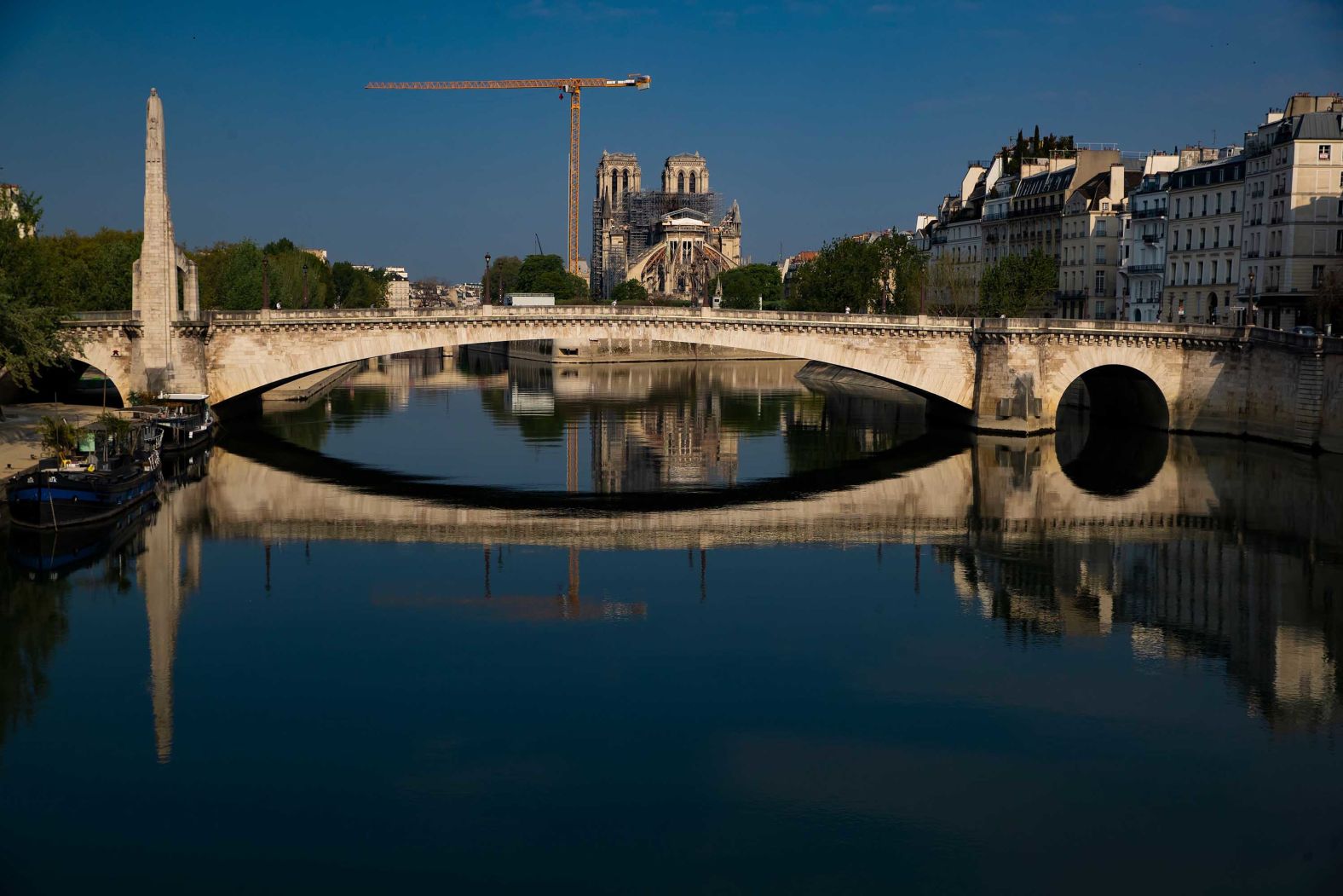 Notre Dame and the Pont de la Tournelle bridge are reflected in the Seine river on Easter Sunday, April 12.