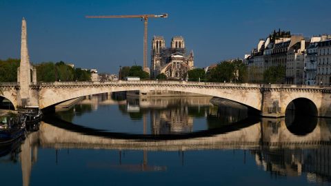 Notre Dame and the Pont de la Tournelle bridge are reflected in the Seine river on Easter Sunday, April 12.