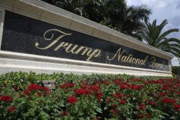 A sign reading Trump National Doral is seen on the grounds of the golf course owned by Donald Trump.