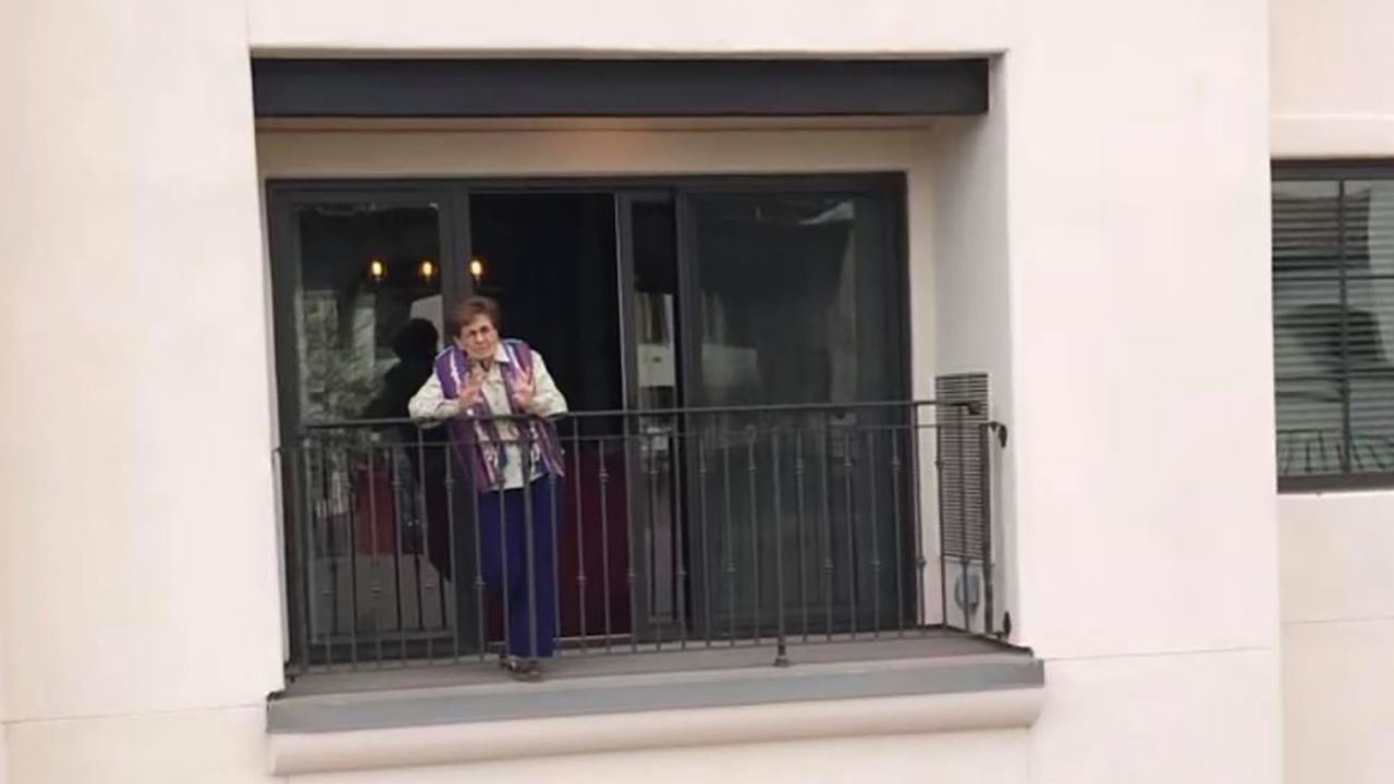 Rosemary Adams waves to her family from her assisted living facility in late March 2020.