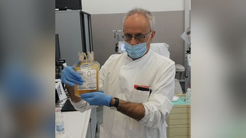 Doctor Cesare Perotti, director of the immunotransfusion service at the University of Pavia San Matteo Hospital, holds a bag of plasma after a donation.
