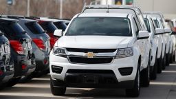 In this Sunday, March 15, 2020, photograph, a long row of unsold 2020 Colorado pickup trucks sits at a Chevrolet dealership in Englewood, Colo. (AP Photo/David Zalubowski)