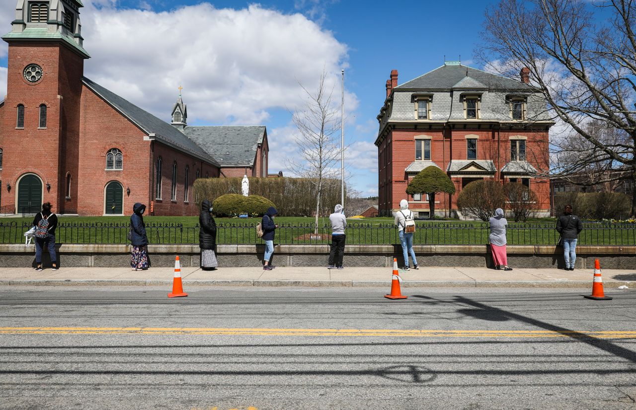 People line up for food assistance in Waltham, Massachusetts, in April.