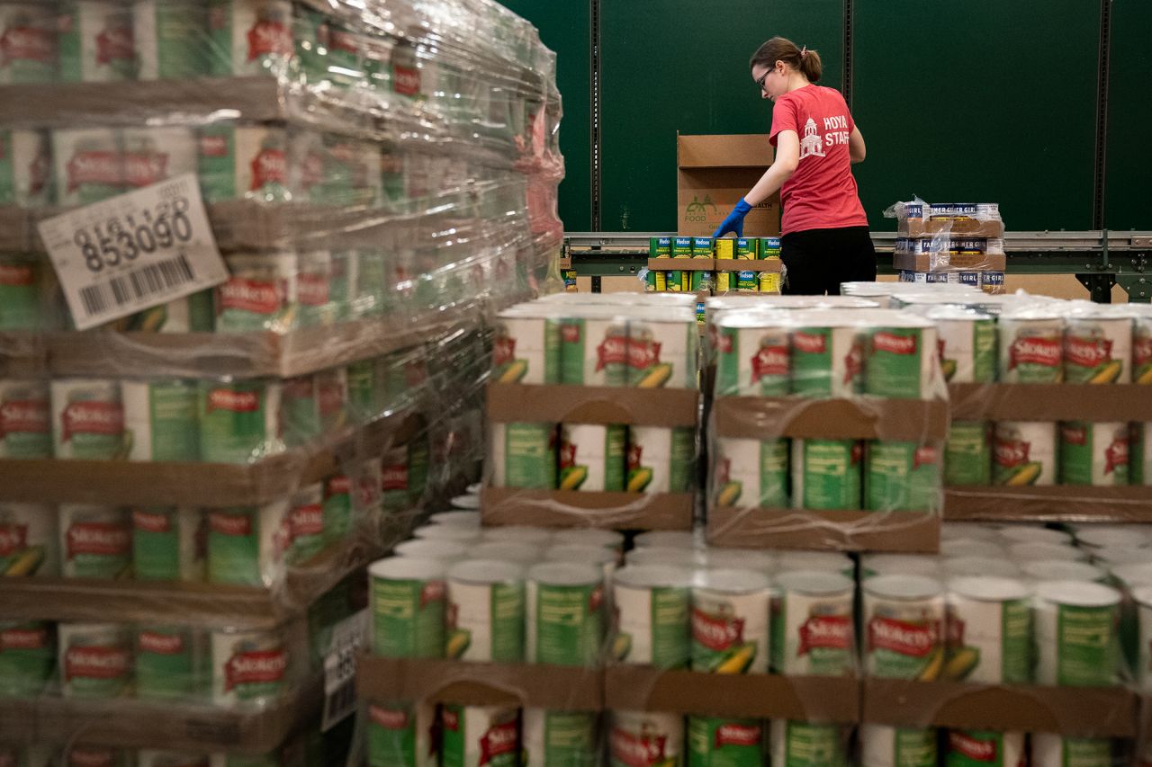 Volunteers at the Capital Area Food Bank pack up boxes of food to be distributed in Washington, DC.