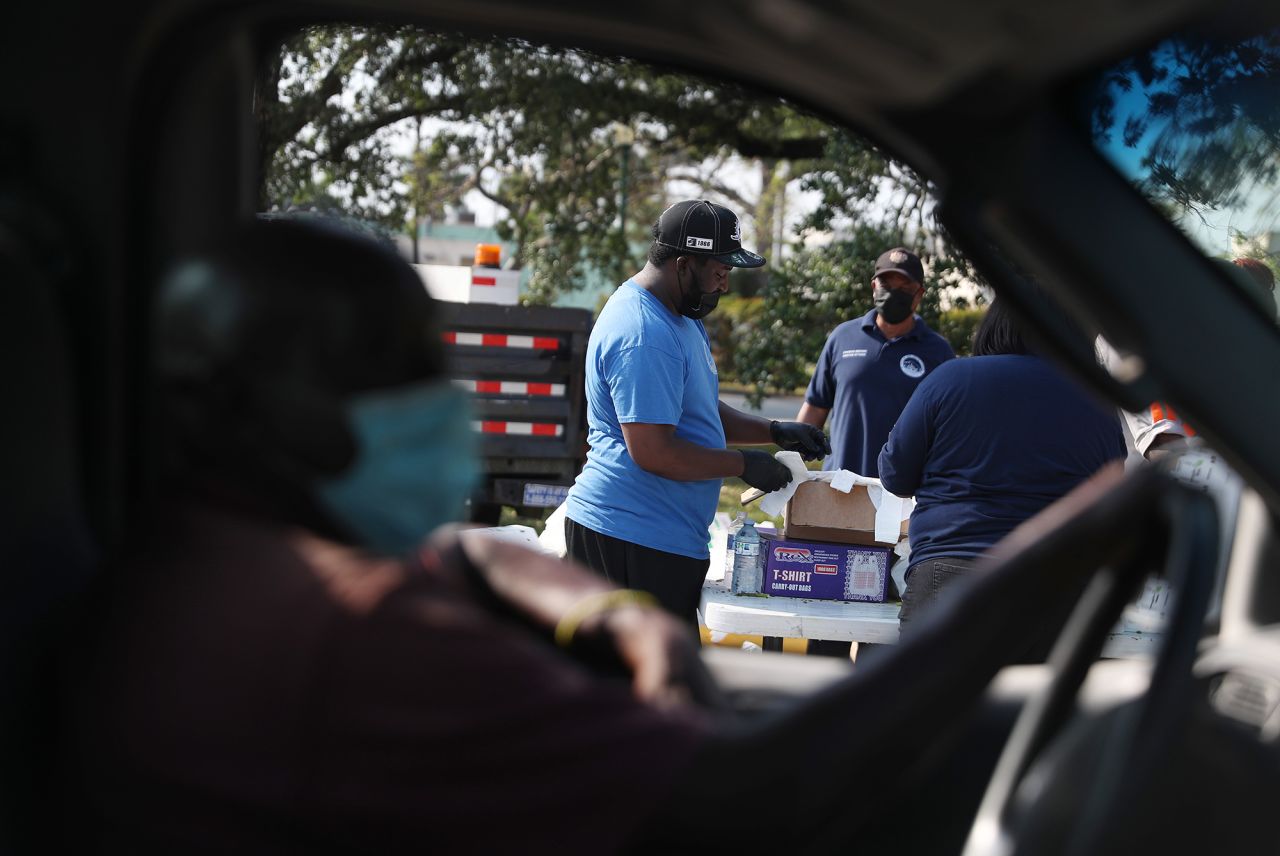 Volunteers and city employees prepare to hand out bags of food at a drive-through site in Opa-locka, Florida, in April. The food was provided by the food bank Feeding South Florida.