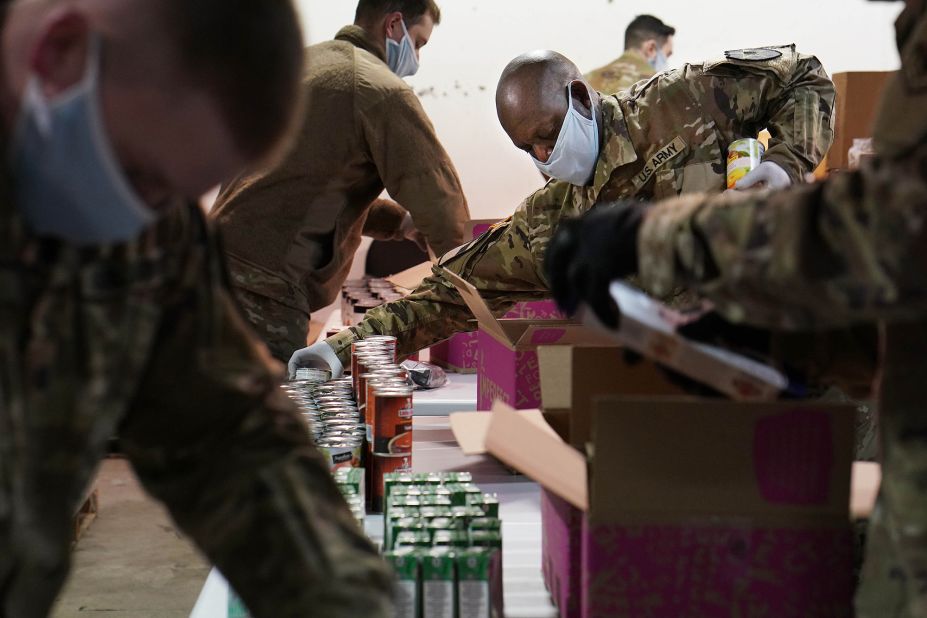 National Guard members help pack food boxes at the Nourish Pierce County food bank in Tacoma, Washington.