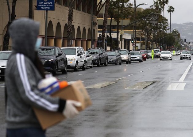 A line of cars waits to receive food at a distribution site in Van Nuys, California, in April.