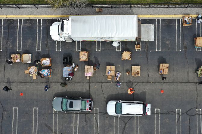 Volunteers with Forgotten Harvest load food into vehicles at a mobile pantry in Detroit.