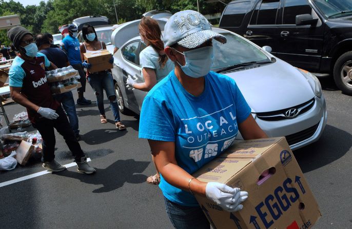 Volunteers in Orlando hand out food from the Second Harvest Food Bank of Central Florida.