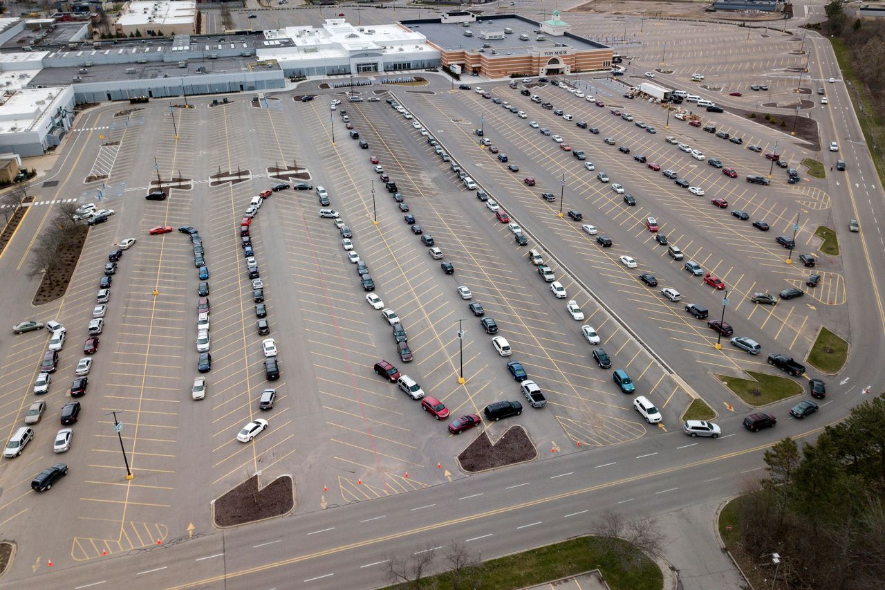 Cars line up in a mall parking lot that was the site of a drive-through food pantry in Grand Rapids, Michigan.