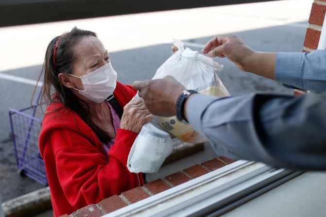 Volunteer David Mack hands a woman food at the First AME Church in Athens, Georgia.