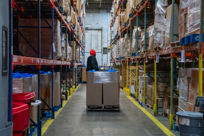 An employee of the Food Bank for New York City transports a pallet of groceries in April.