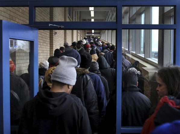 People line up for food at Sharing & Caring Hands, a charity in Minneapolis, in March.