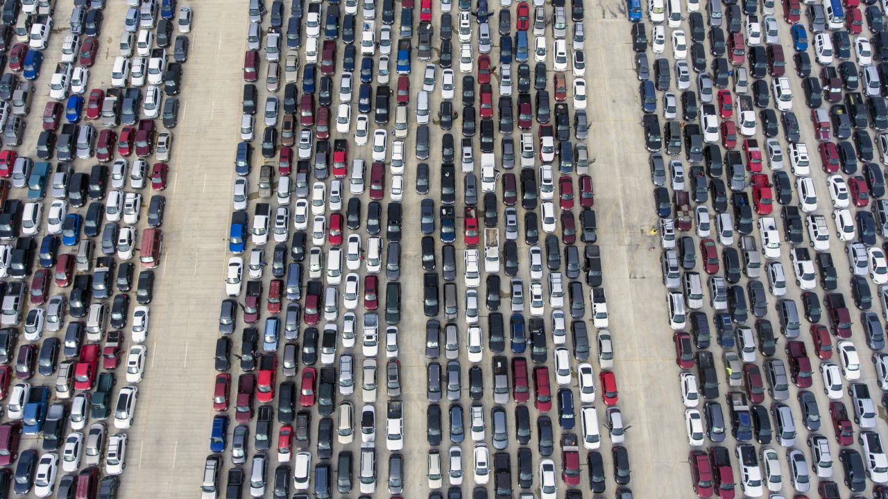 People wait in their cars Thursday, April 9, 2020, at Traders Village for the San Antonio Food Bank to begin food distribution. The need for emergency food aid has exploded in recent weeks due to the coronavirus epidemic. (William Luther/The San Antonio Express-News via AP)