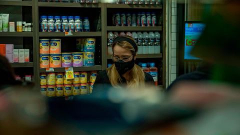 A grocery cashier is seen wearing a protective face mask in Brooklyn, New York, March 20, 2020, (Marshall Ritzel via AP)