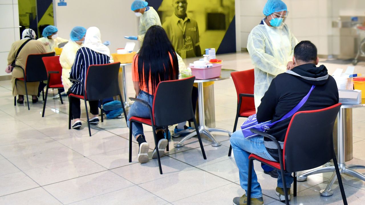 The Dubai Health Authority carries out coronavirus screening on passengers heading to Tunisia on a repatriation flight.