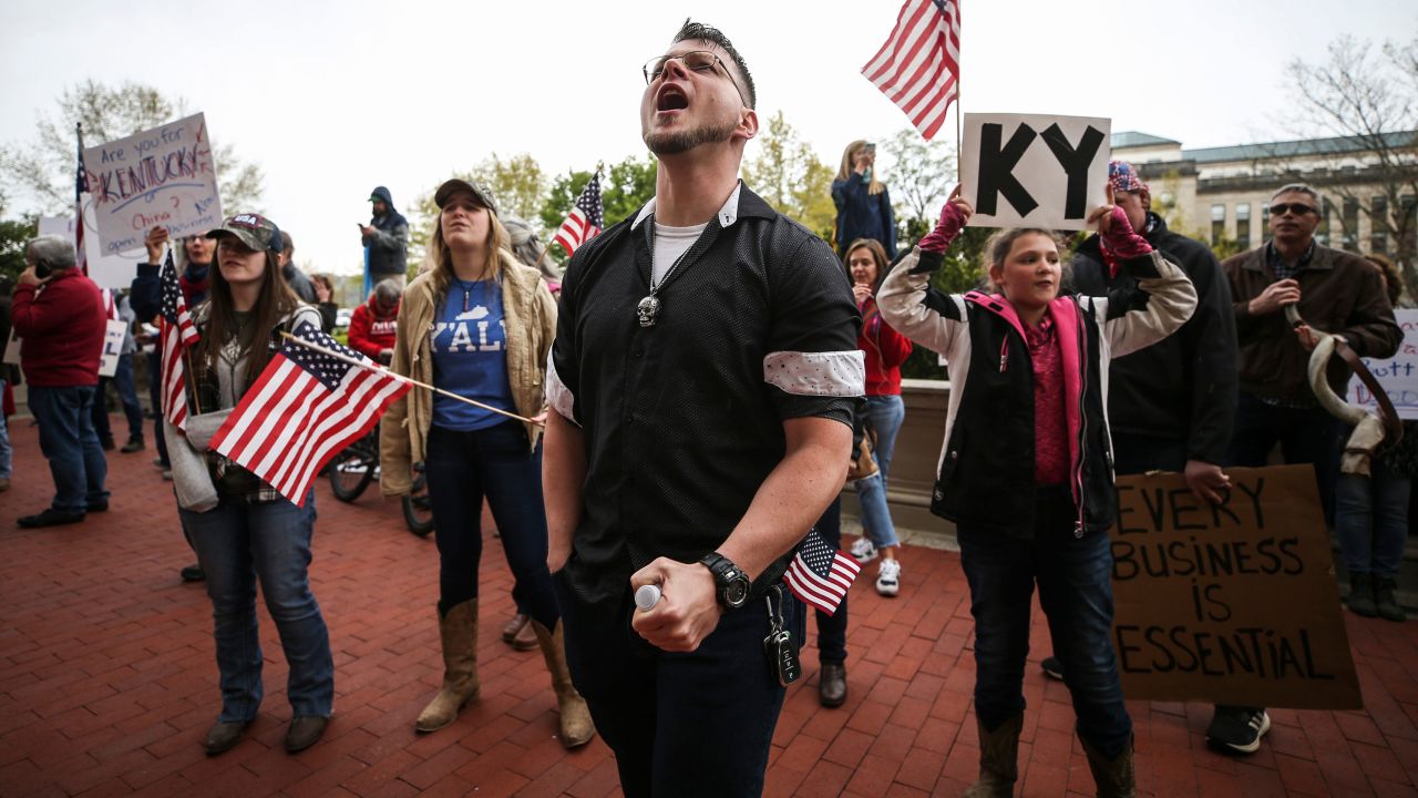Protestors yell "Open Up Kentucky!" and "You're not a king, we won't kiss your ring" outside the room where Gov. Andy Beshear was giving his daily coronavirus update on April 15 in Frankfort, Kentucky.