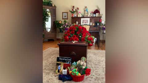 A small group of mourners gathered for a home Mass honoring Martha Palacios. More than 100 others participated in the service online.