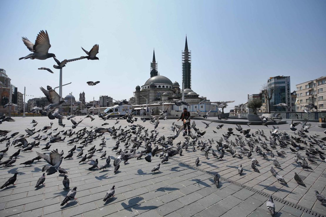 Pigeons fly around a deserted Taksim Square after a two-day curfew imposed to stem the spread of coronavirus in Istanbul.