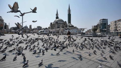 Pigeons fly around a deserted Taksim Square after a two-day curfew imposed to stem the spread of coronavirus in Istanbul.