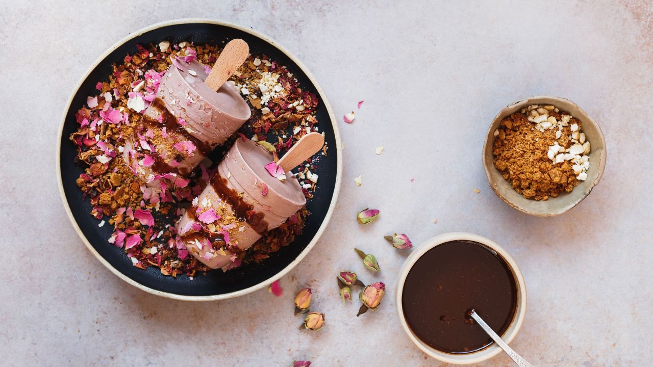 This masala chai kulfi is served with biscuit crumbles, chocolate syrup and some dry rose petals on top.