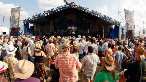 Fans listen to the New Orleans Nightcrawlers Brass Band perform on the Jazz and Heritage stage during the New Orleans Jazz and Heritage Festival at the Fair Grounds Race Course on May 1, 2008 in New Orleans, Louisiana.