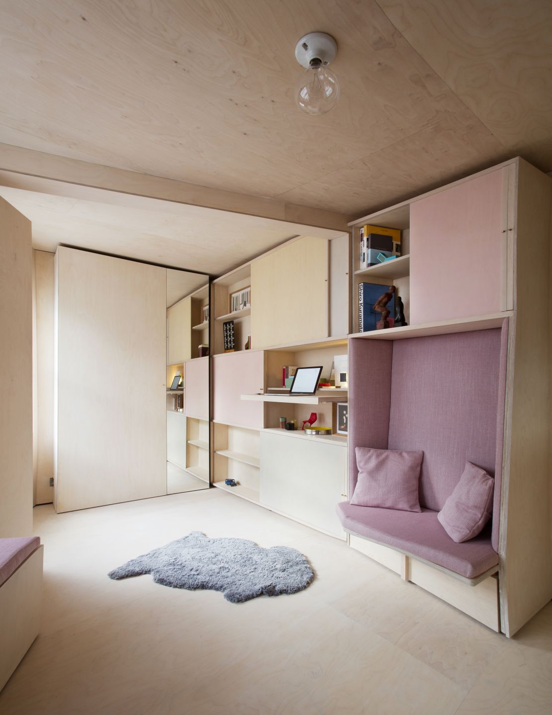 London-based design firm Studiomama created a small working area that folds into the wall in this 140-square-foot apartment project.