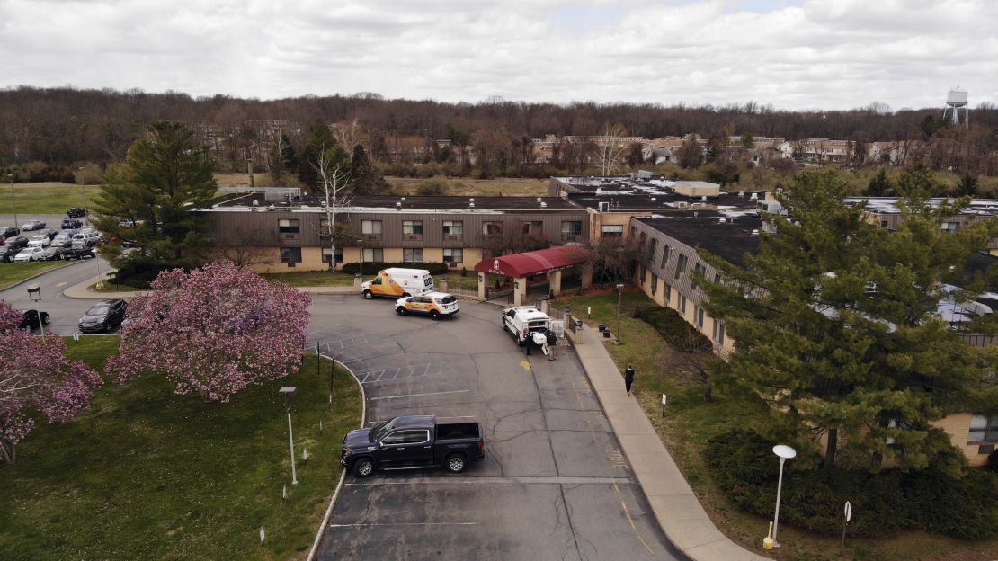 Ambulance crews are parked outside Andover Subacute and Rehabilitation Center on Thursday.   