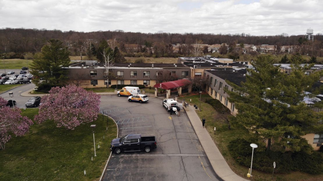 Ambulance crews are parked outside Andover Subacute and Rehabilitation Center on Thursday.