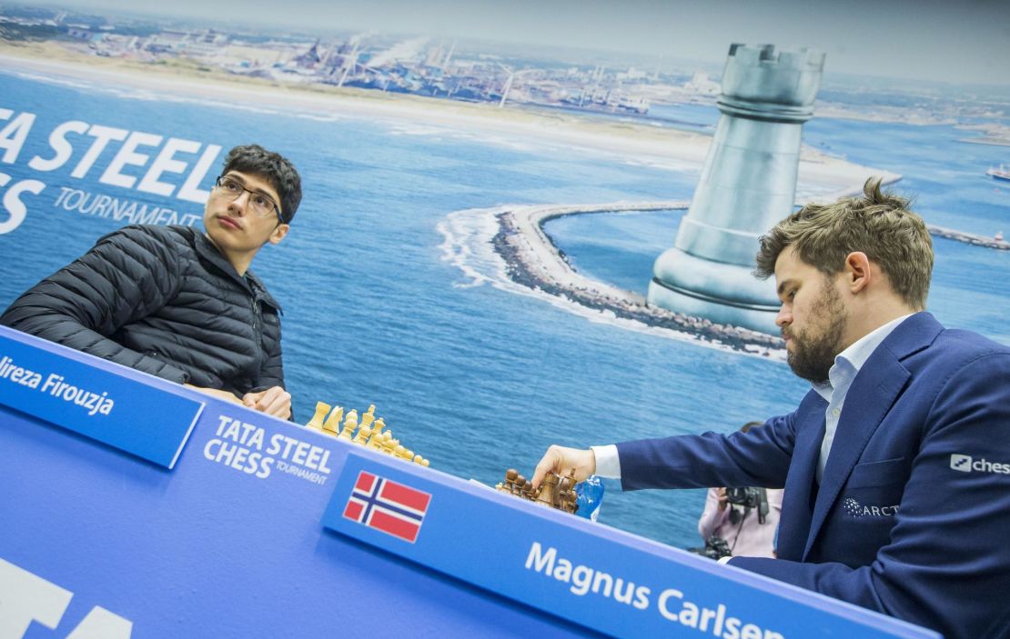 Firouzja (left) faces World Champion Carlsen during the 9th round of the Tata Steel Chess Tournament.