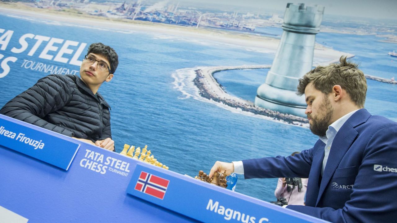 Firouzja (left) faces World Champion Carlsen during the 9th round of the Tata Steel Chess Tournament.
