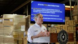 Boxes of medical personal protective equipment provide the backdrop as Texas Gov. Greg Abbott gives an update on the COVID-19 outbreak at the Texas Department of Public Safety warehouse facility in Austin, Texas, Monday, April 6, 2020.